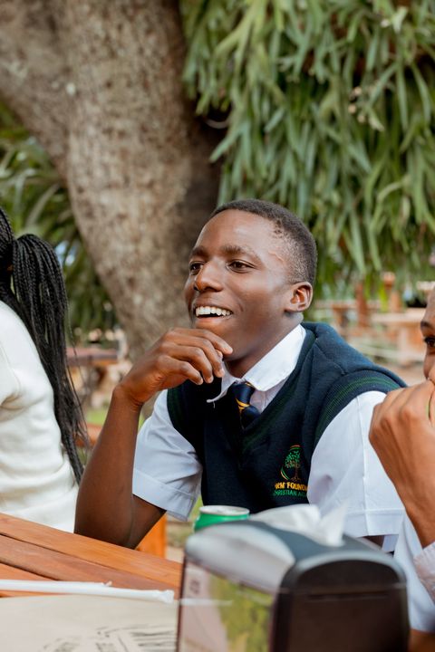 A uniformed learner enjoying the school restaurant outing