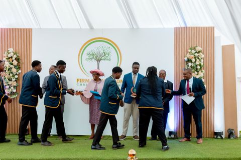 Uniformed learners receiving recognition on the prize-giving stage