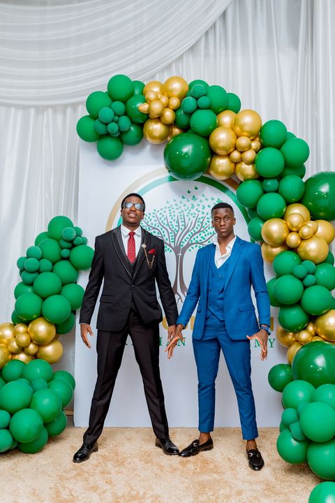 Prom guests posing in front of the school backdrop during the celebration