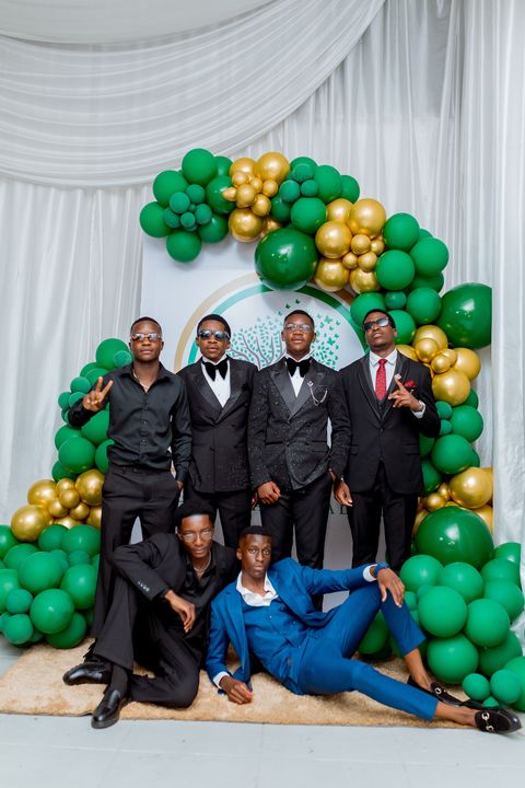 Prom guests gathered for a group portrait with the school crest behind them