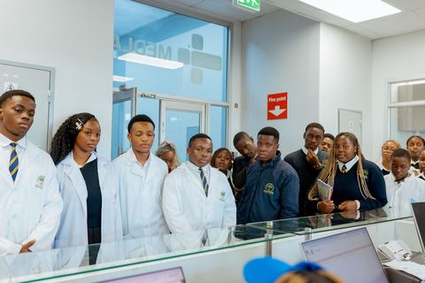 Learners observing laboratory equipment during an off-campus CIMAS educational visit