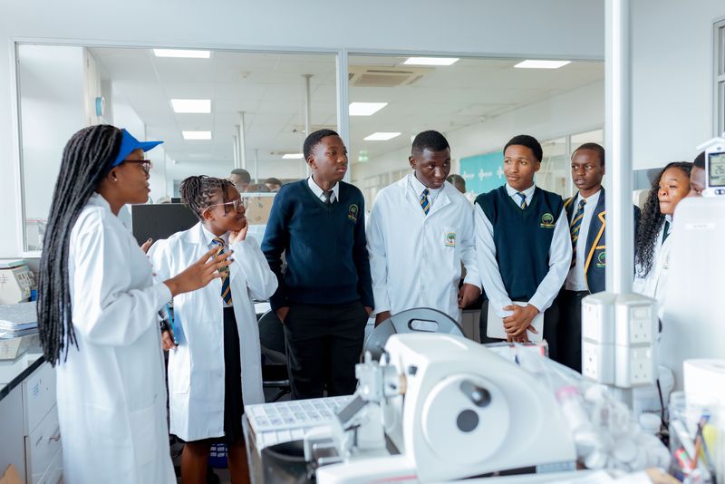 Uniformed learners listening to a guide during an educational visit to CIMAS