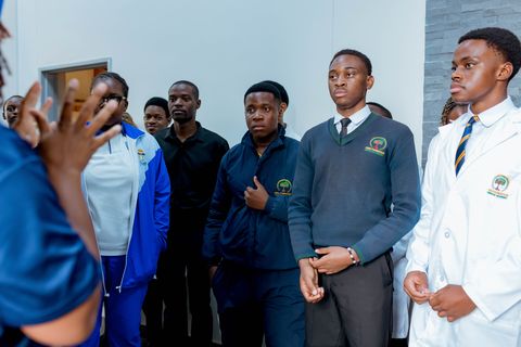 Uniformed learners listening during an educational visit to CIMAS