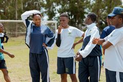 Learners in school sports uniforms spending time together on the field