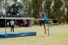 A learner taking part in high jump on the school grounds